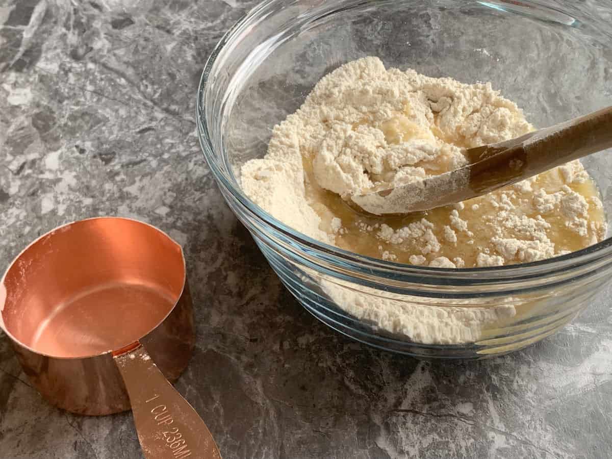 The melted clarified butter added to the flour sugar mixture. 