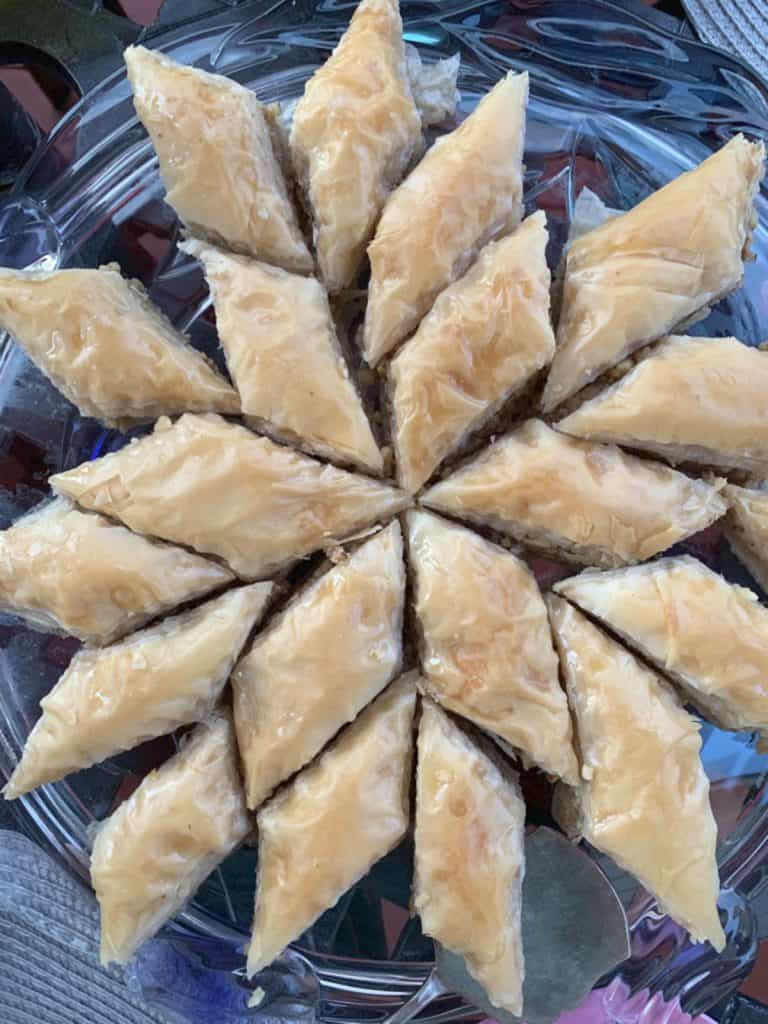 Pakhlava pieces on a glass tray.