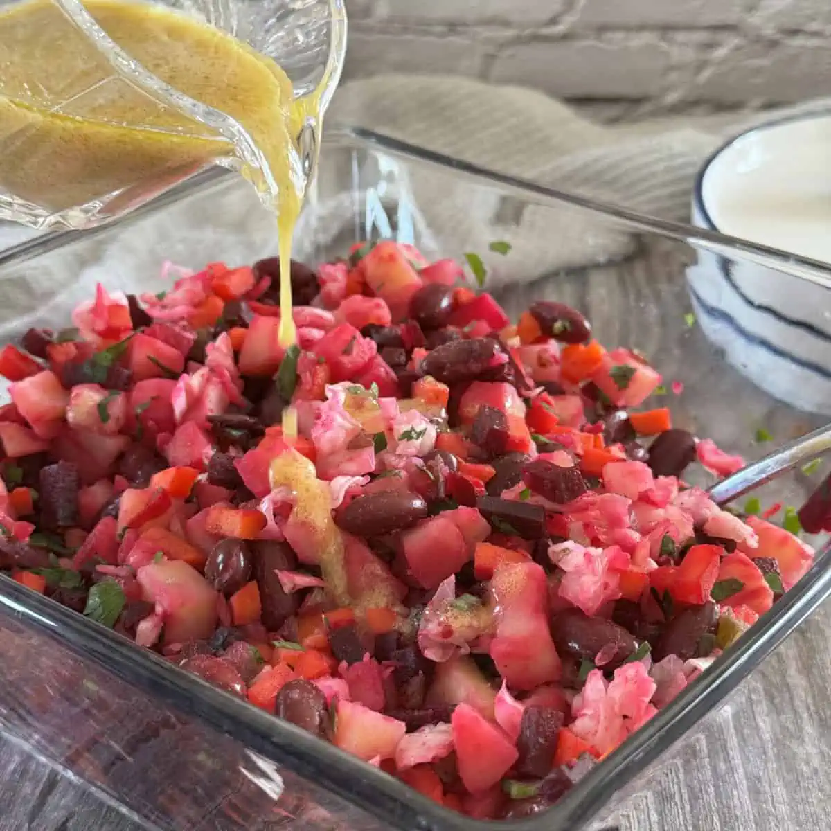 Vinegret beetroot potato salad drizzled by vinaigrette dressing.