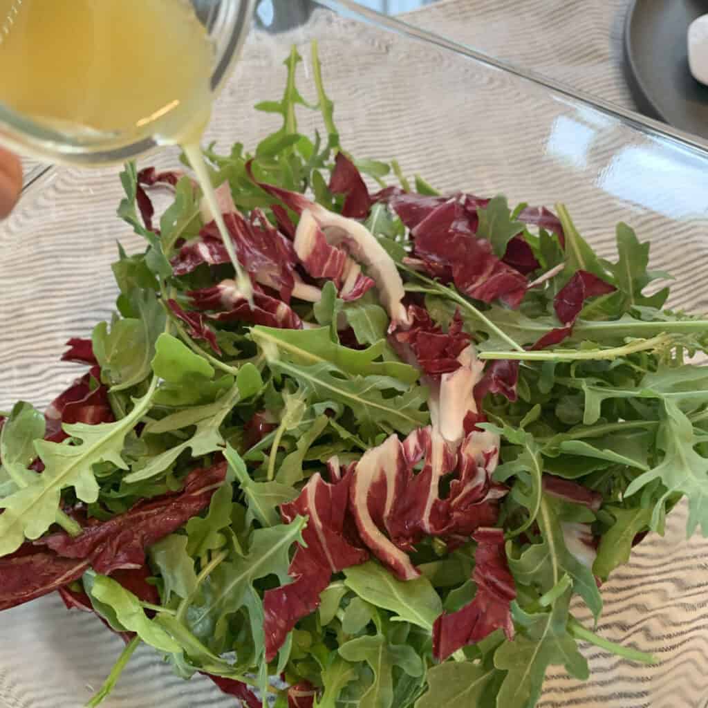 Drizzling the dressing.