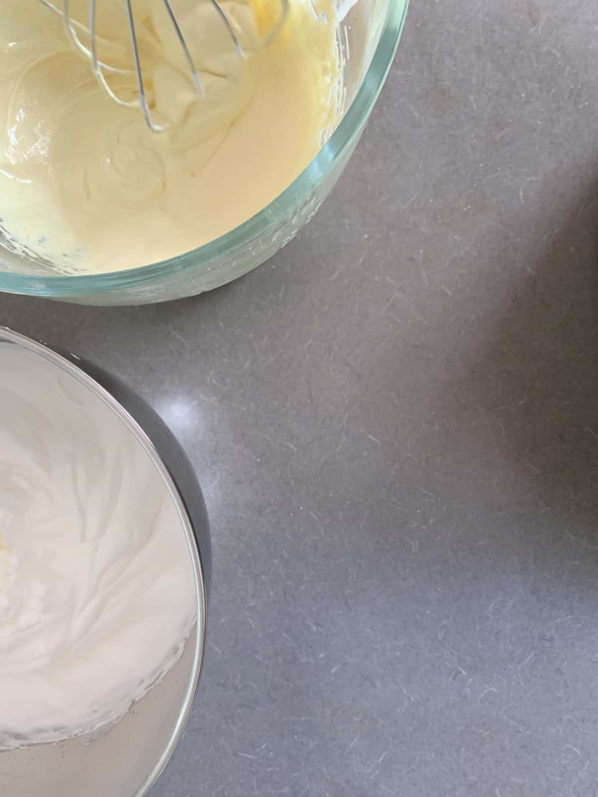 Whipped egg whites and yolks in separate bowls.
