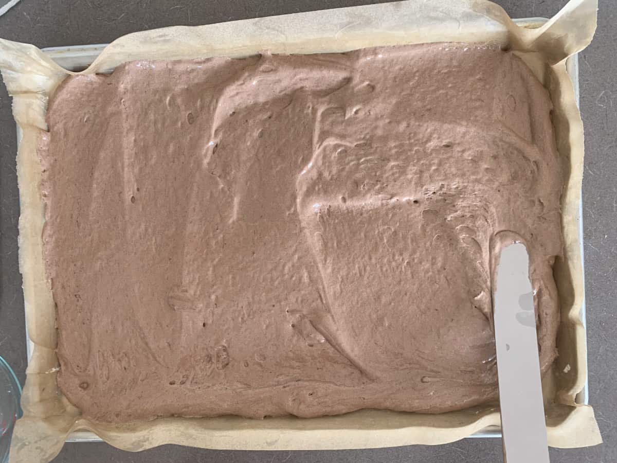 Spreading batter on a sheet pan.