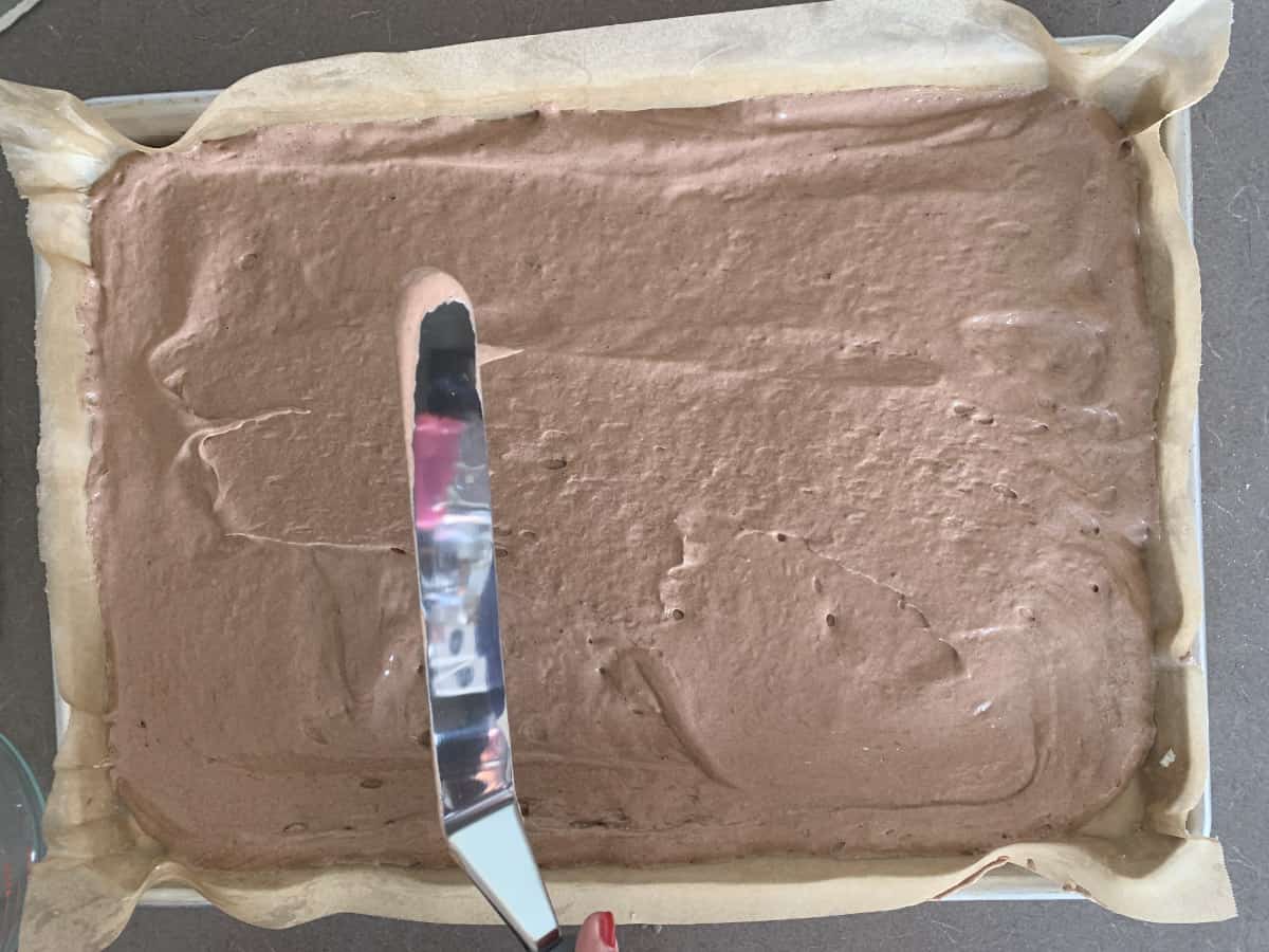 Spreading batter on a sheet pan.
