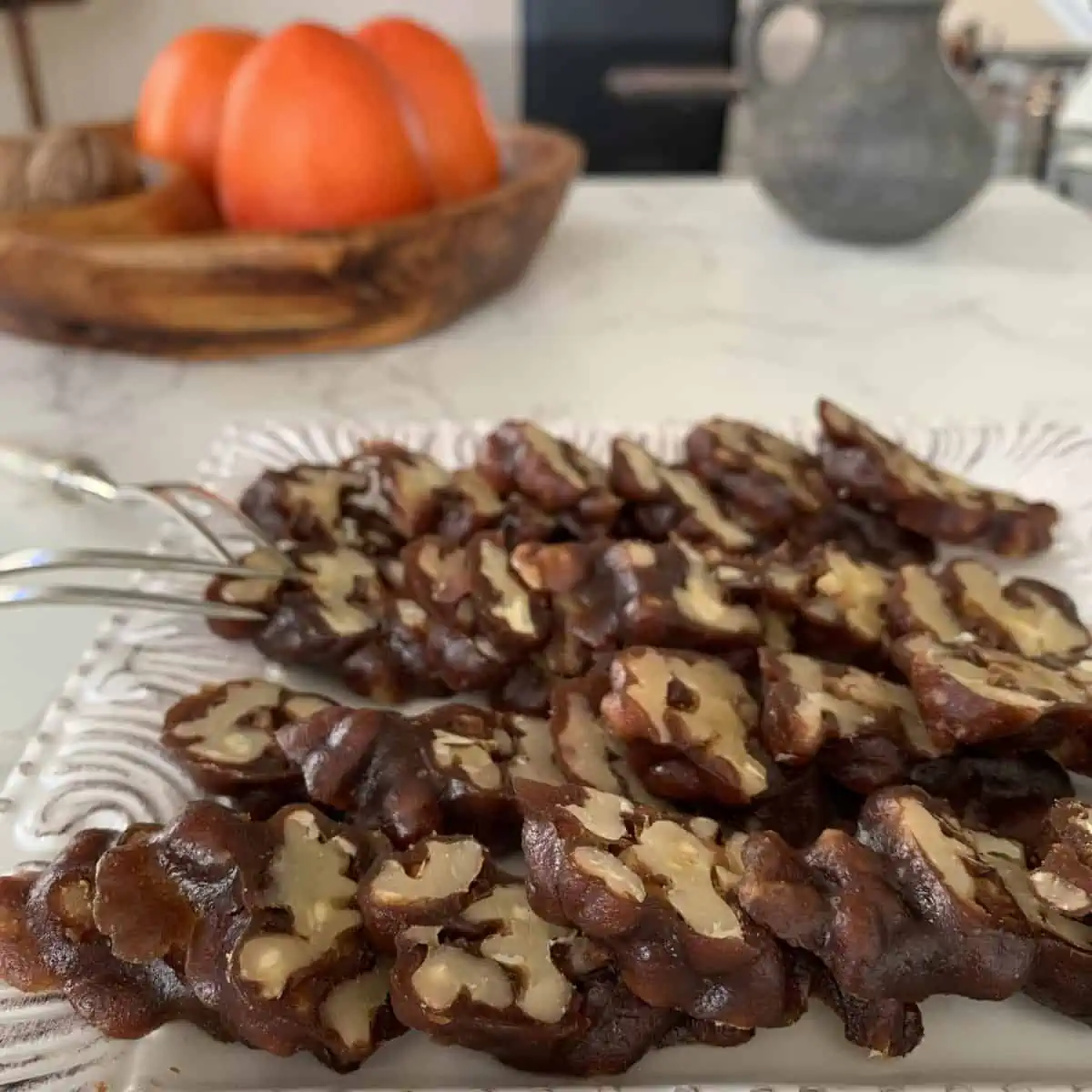Sweet sujukh is cut and arranged on a white plate.