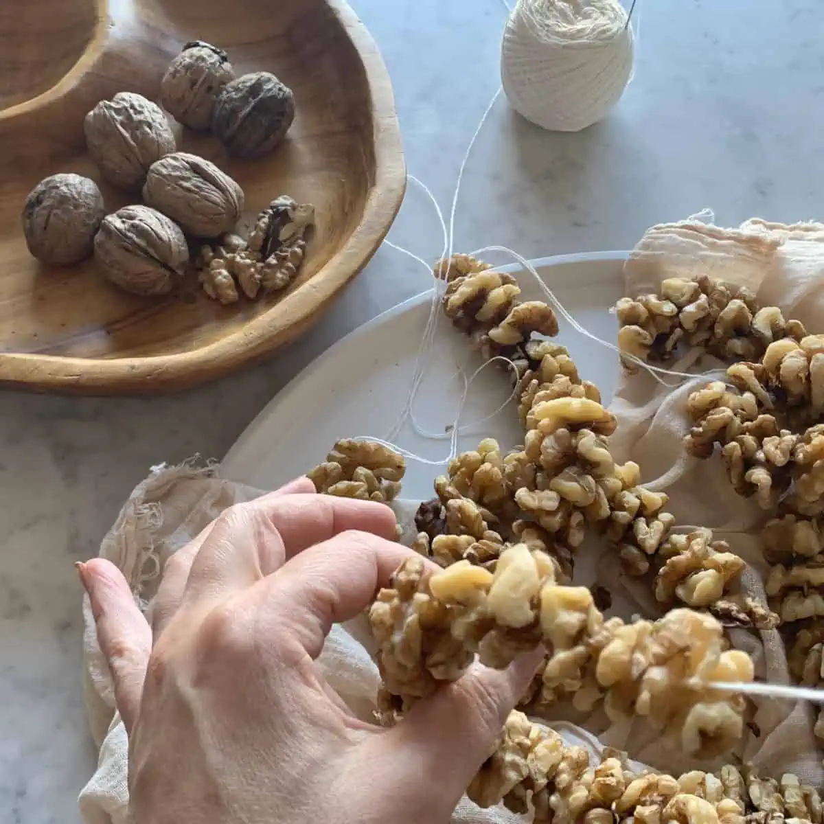 Stringing the walnuts.