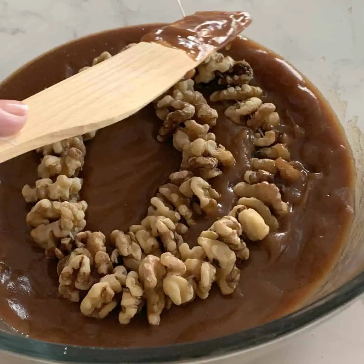 Dipping walnut string in shpot.