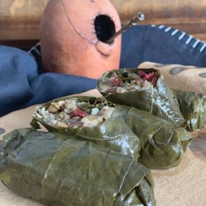 Grape leave legume tolma on a plate.