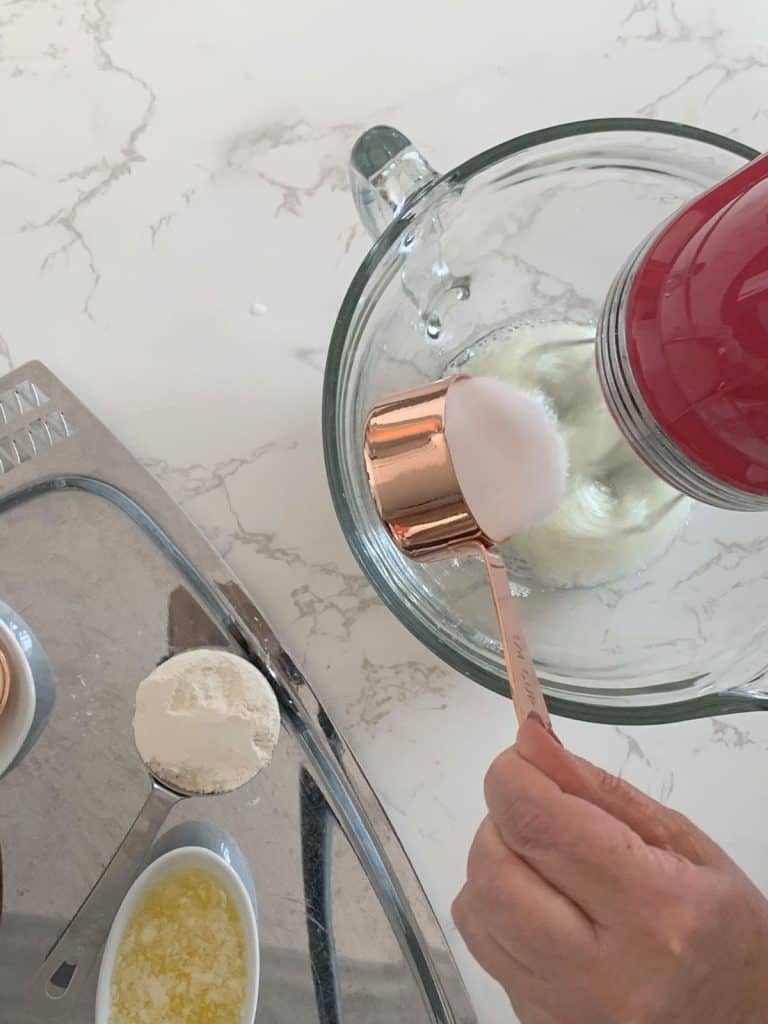 Adding sugar to egg whits.