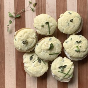 Goat cheese stuffed artichoke bottoms on a cutting board.