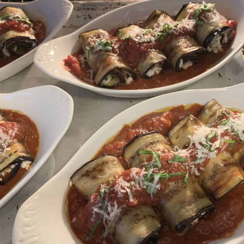 Individual baking dishes on a sheet pan ready to go into the oven.