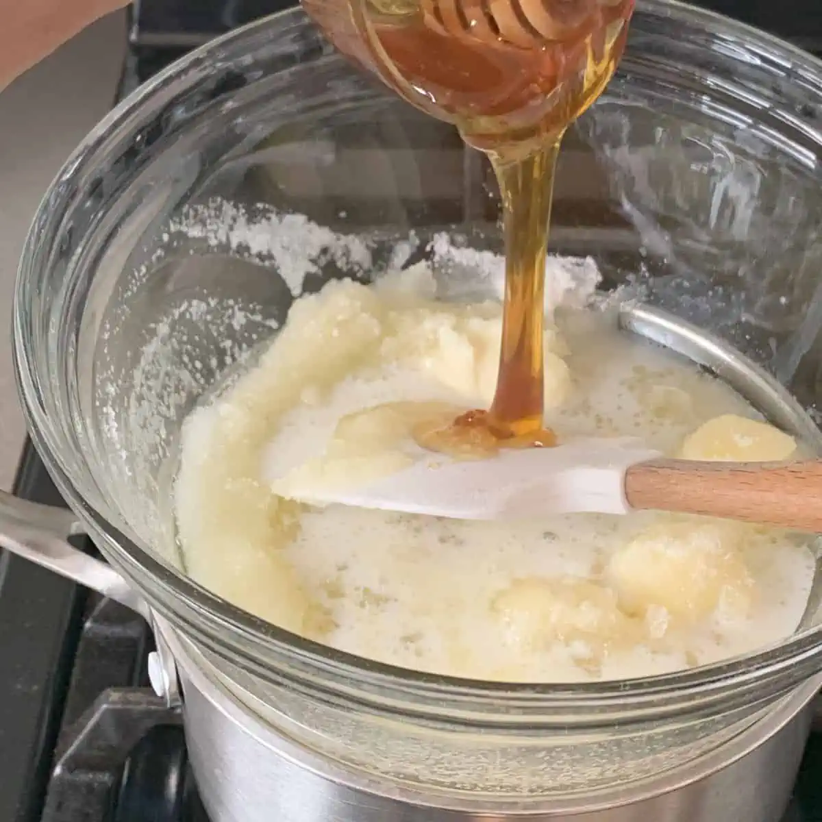 Adding honey to the butter sugar mixture.