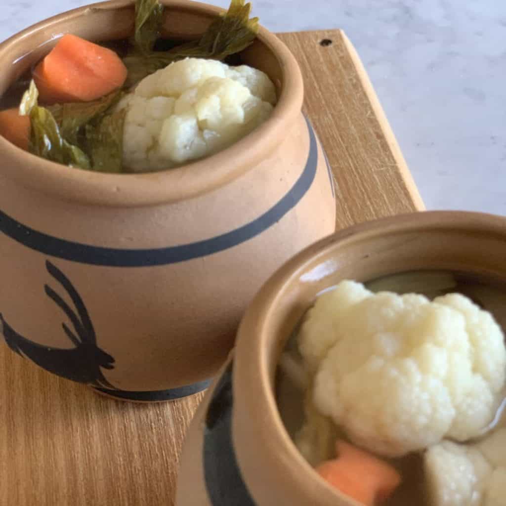 Pickled vegetables in a clay pot.
