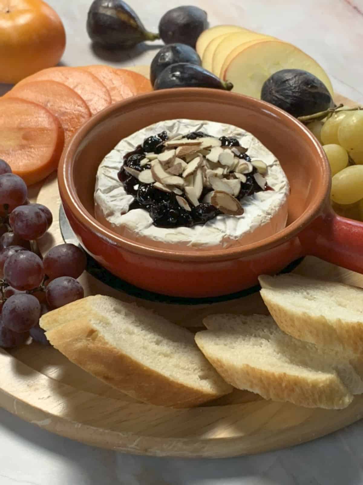 Baked-Brie-Blackcurrant jam with apples, baguette toasts, persimmon, grapes.