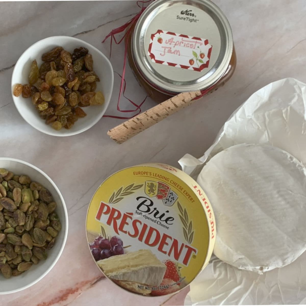 Brie, apricot jam, golden raisins, and pistachio.