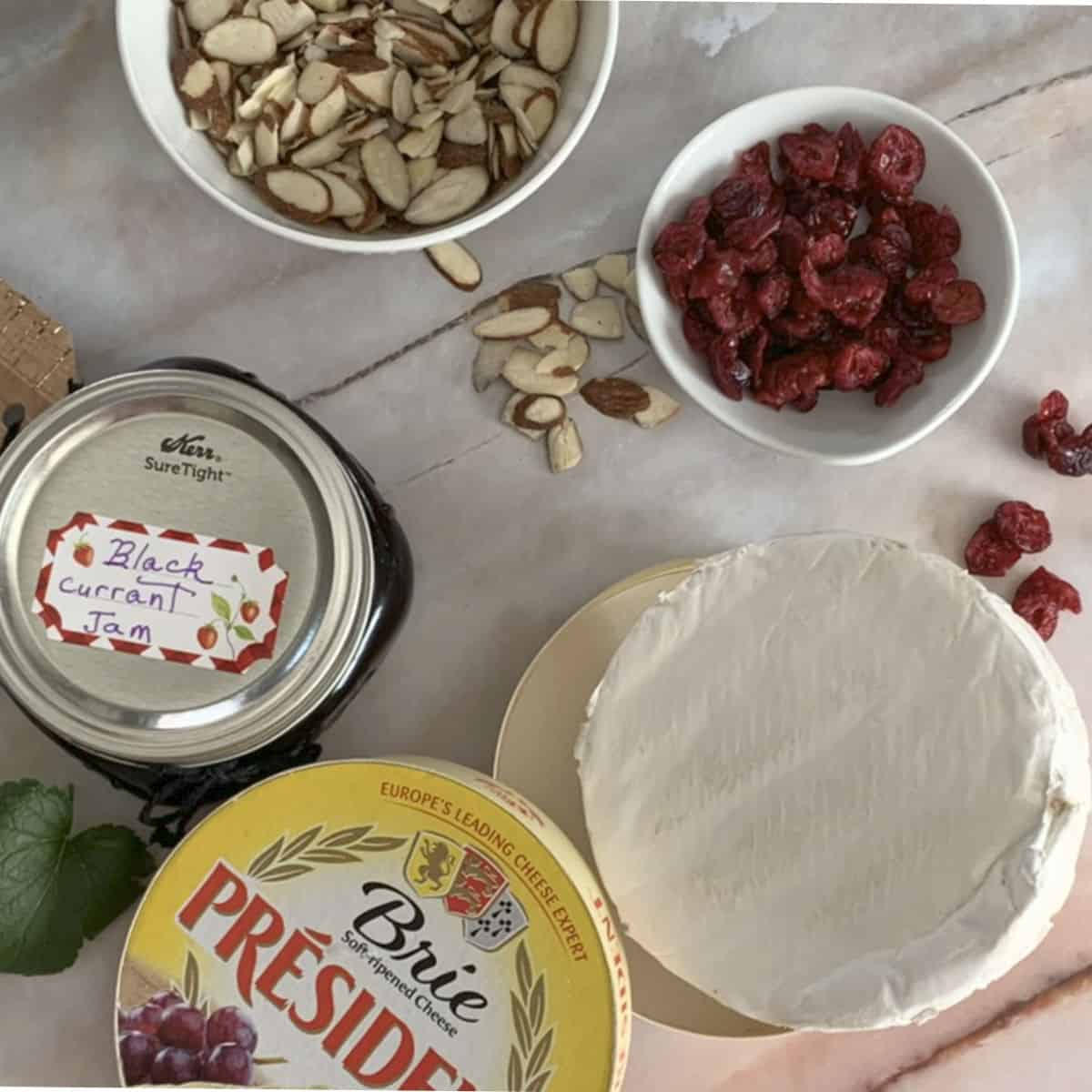 Brie, blackcurrant jam, cranberries, and almonds.