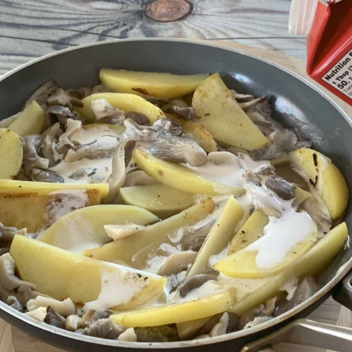 Adding cream to oyster Mushroom and Potatoes.
