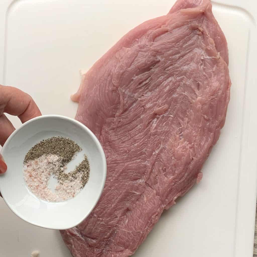 Seasoning the meat.