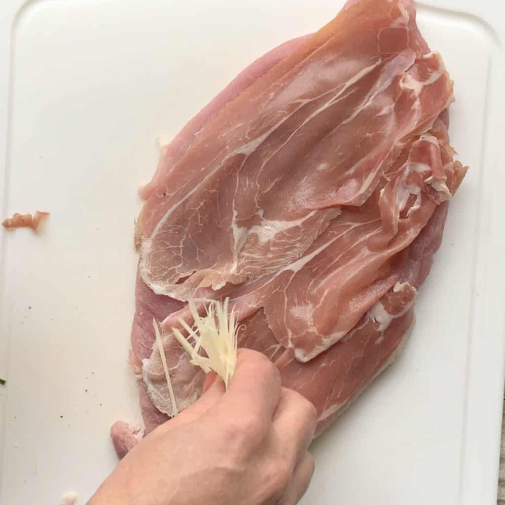 Laying the slices of prosciutto.