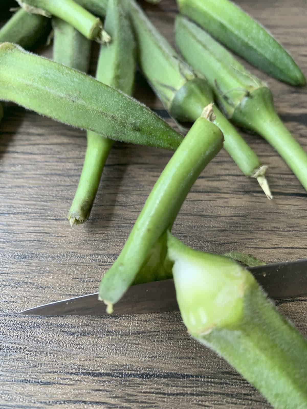 Trimming okra for the stew.