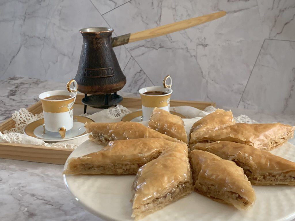 Platter with diamond shaped baklava with Armenian coffee in the background.
