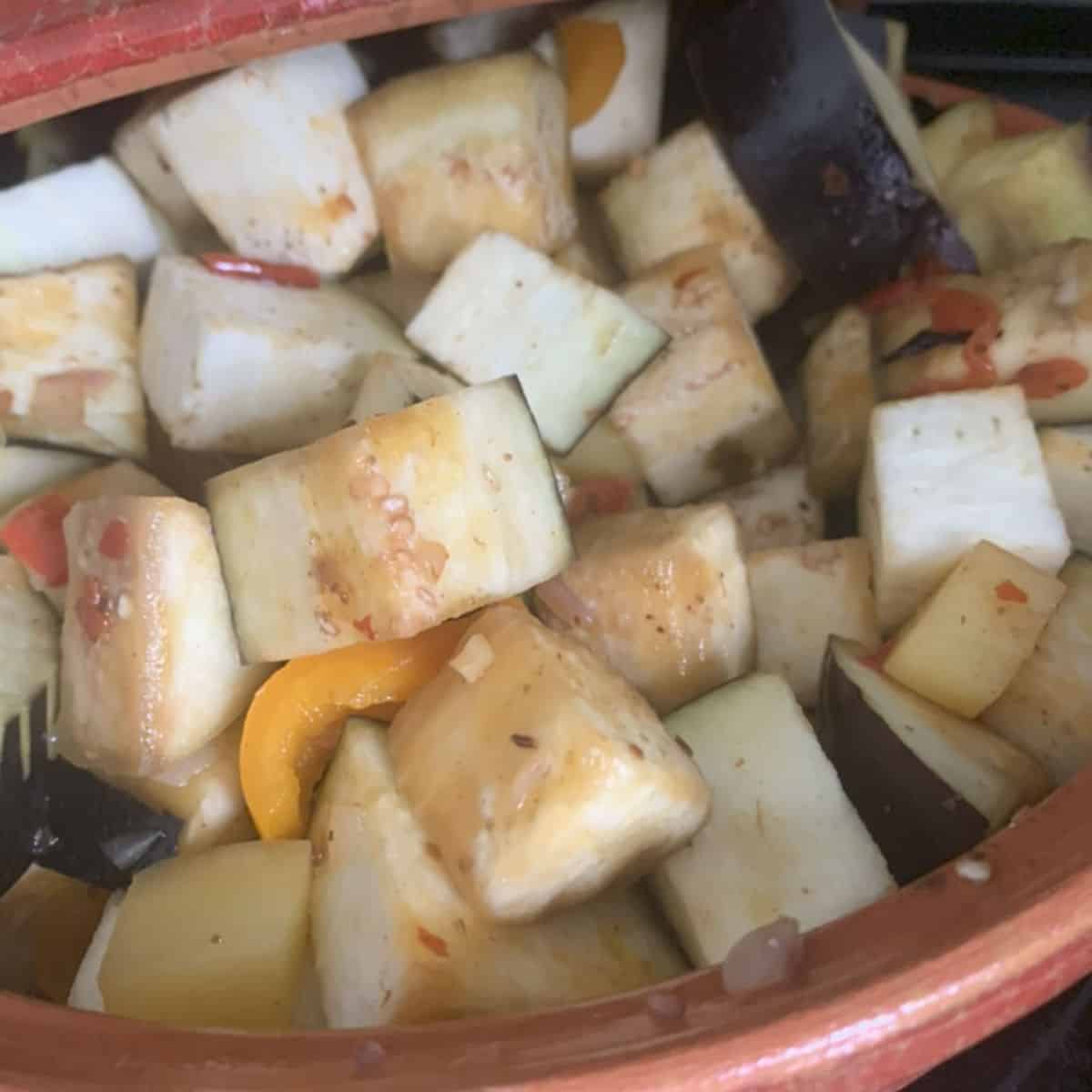 Adding eggplants to the tajine.