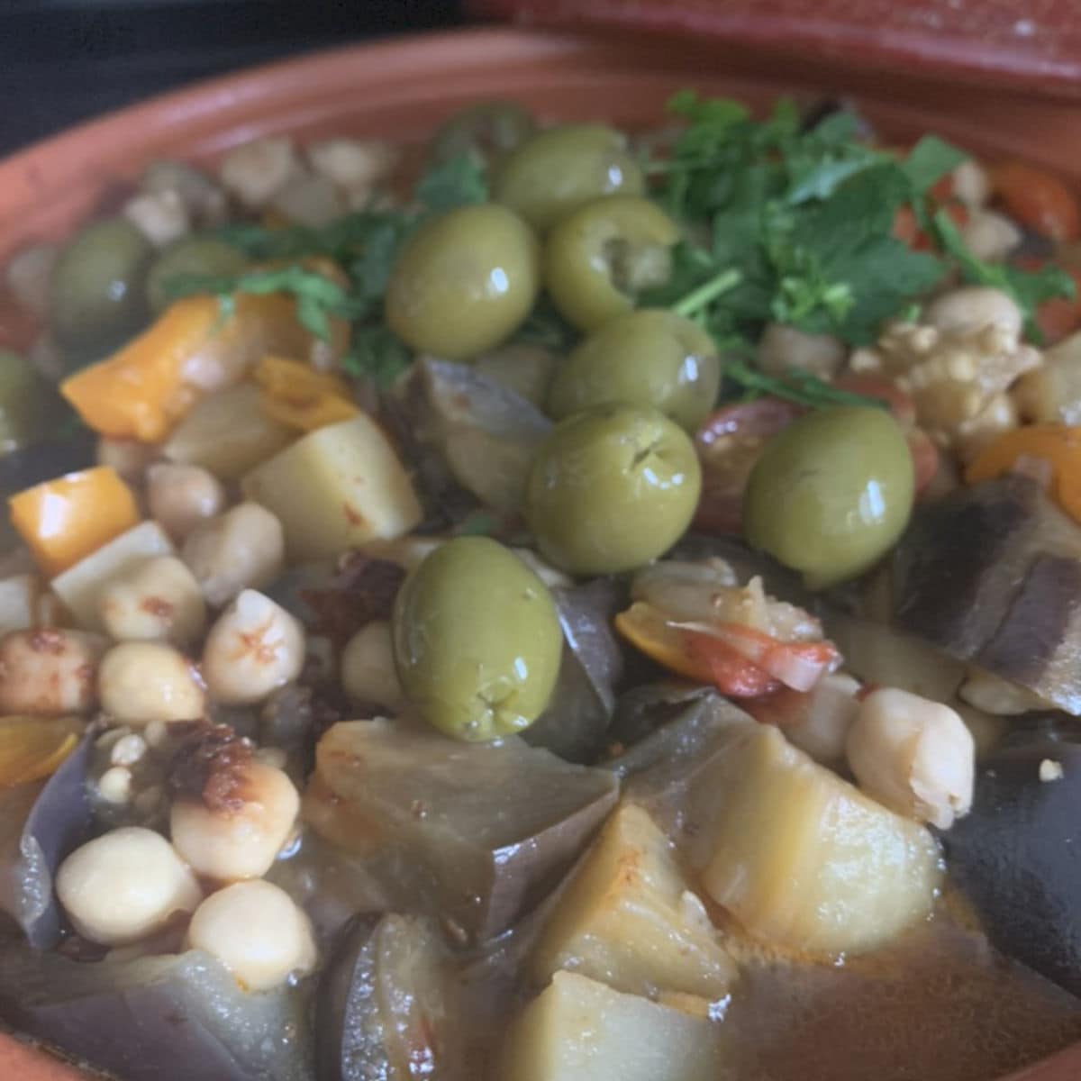 Adding olives to the tajine.