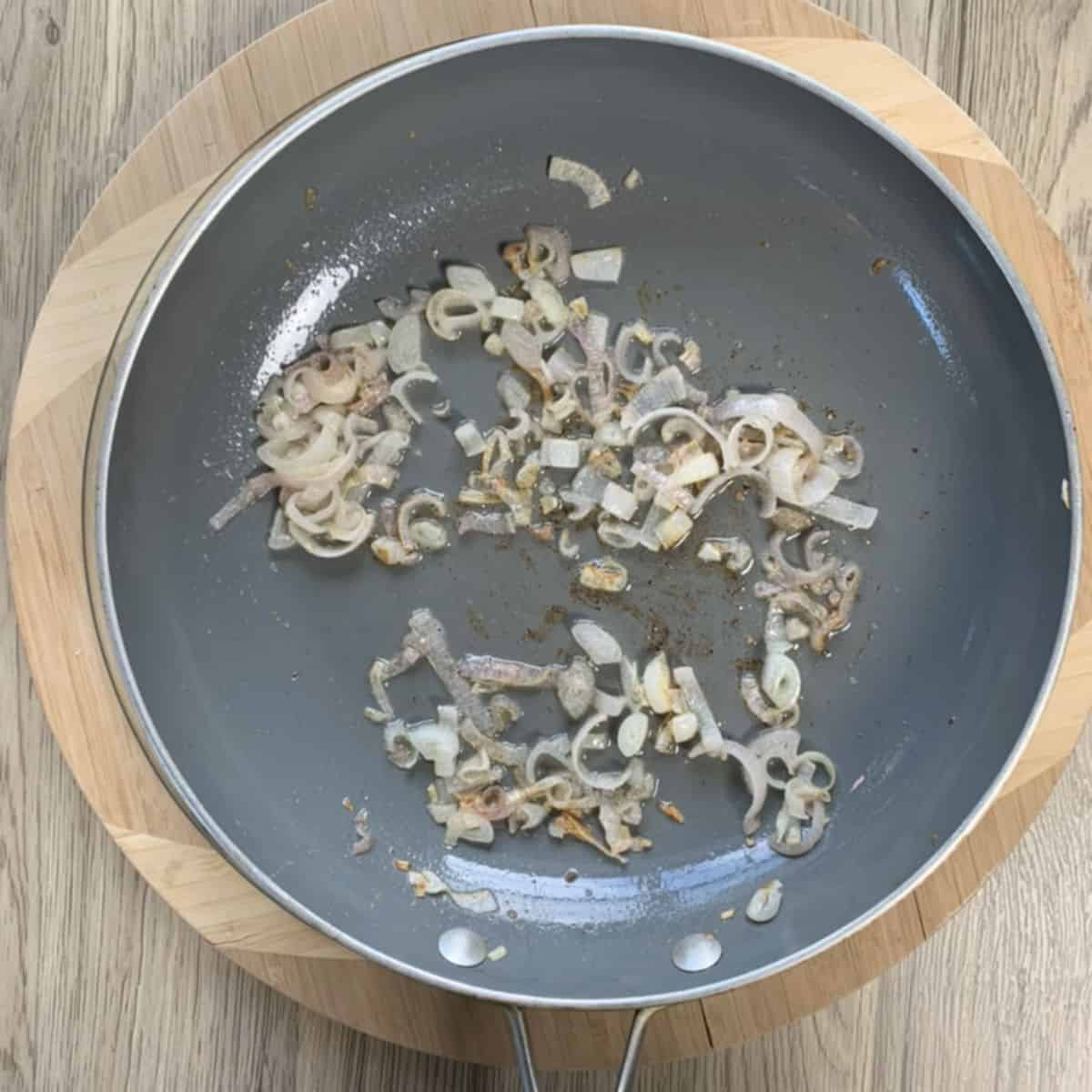 Sauté shallots in a frying pan.