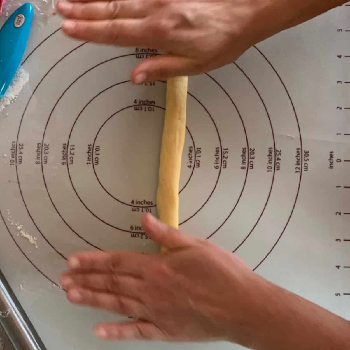 Rolling the dough into a rope to make the braids.