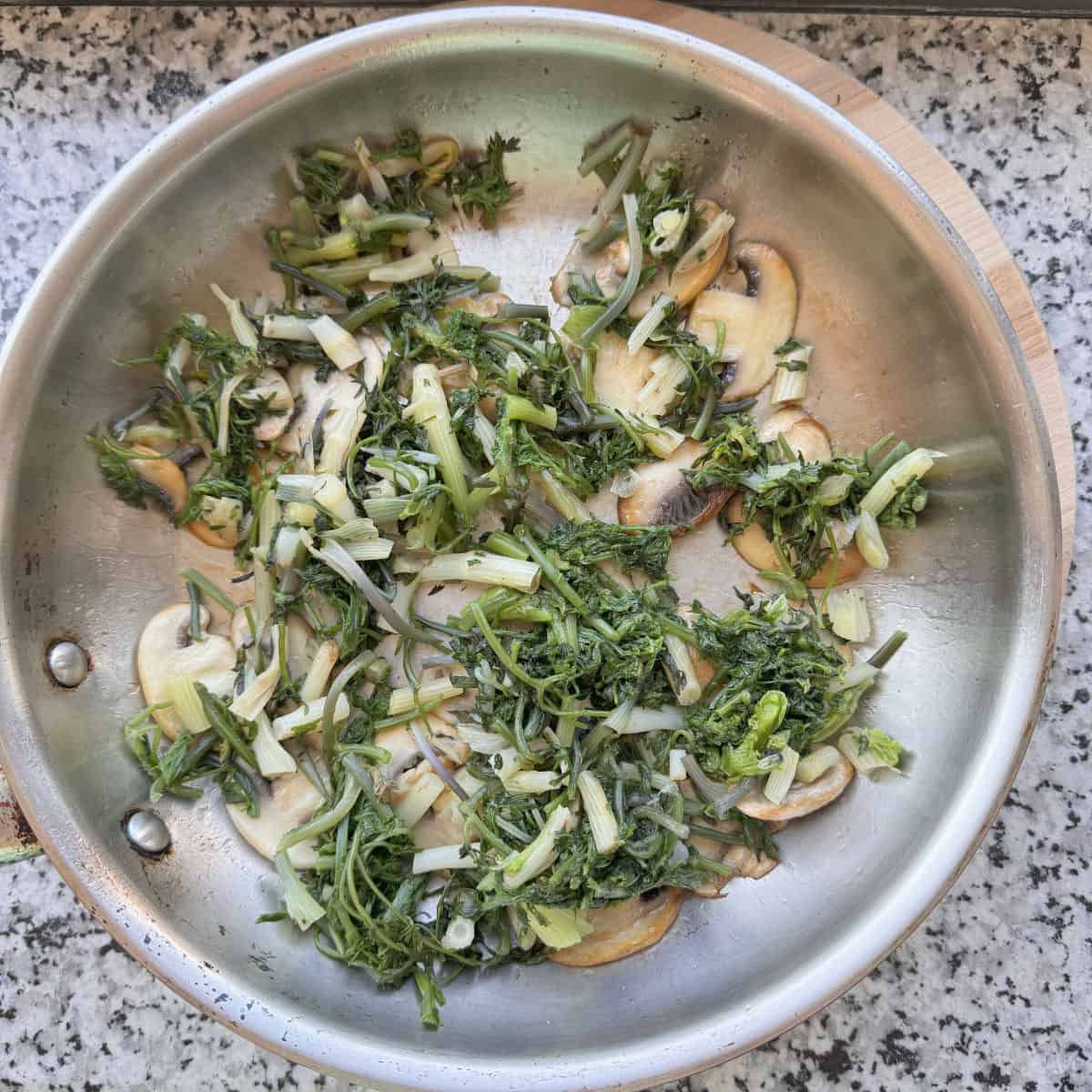 A pan of mushrooms and shushan on a counter.