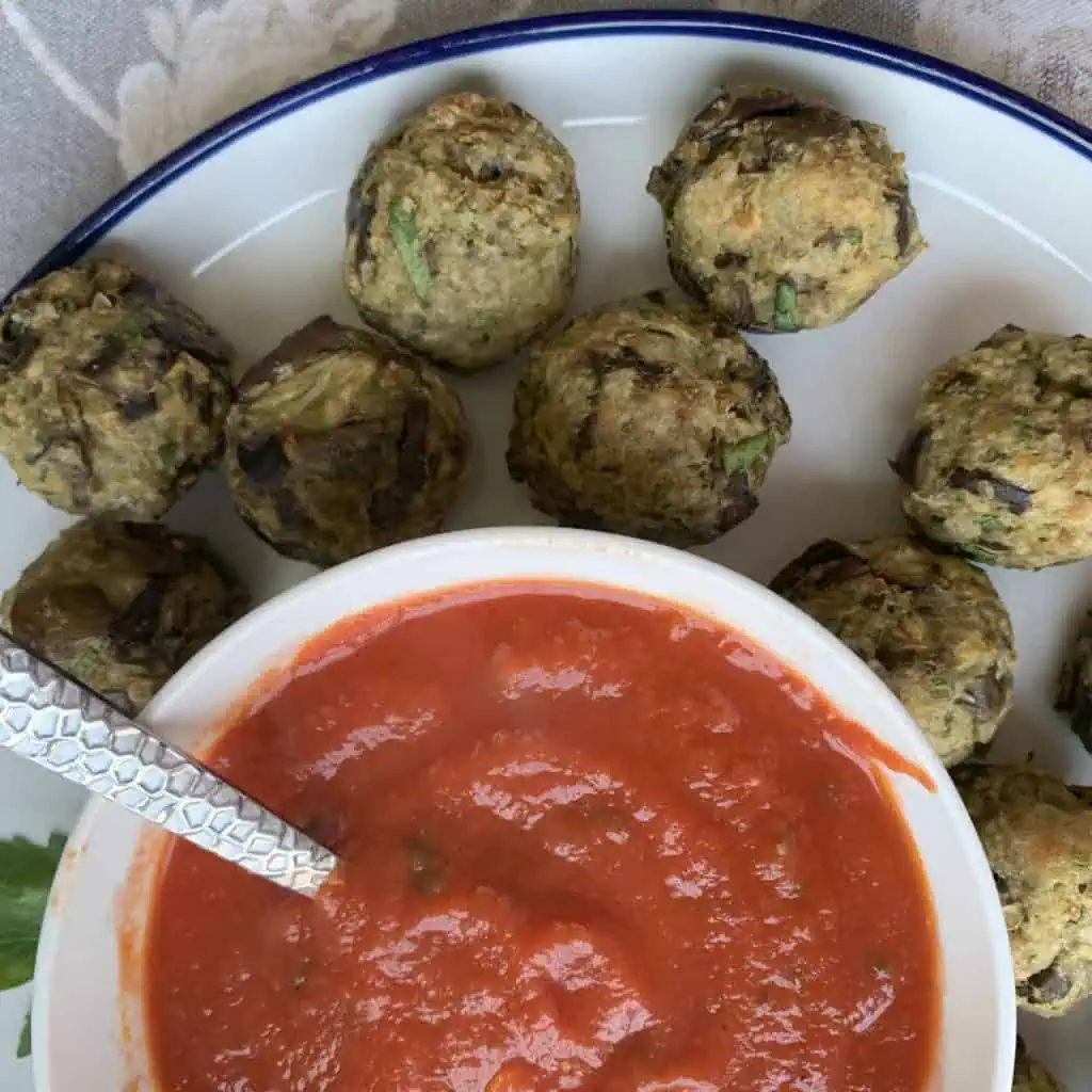 Eggplant meatballs with red sauce.