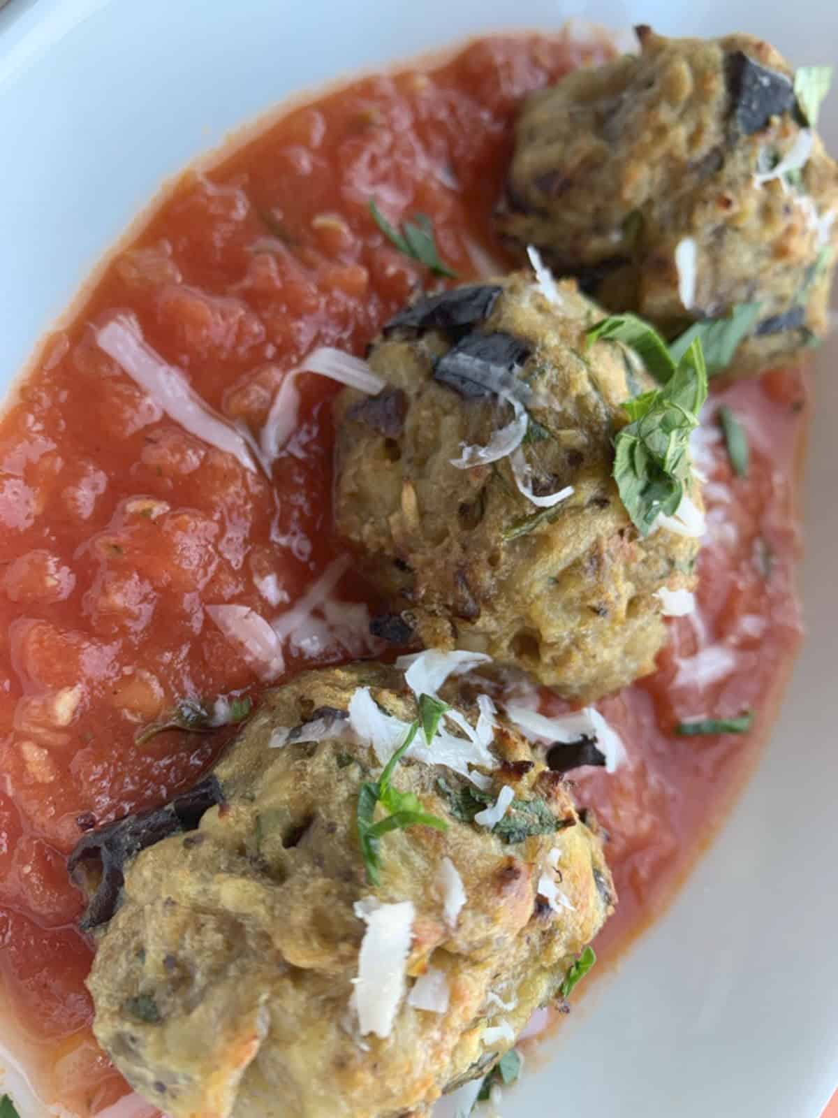 Eggplant balls in a red sauce.