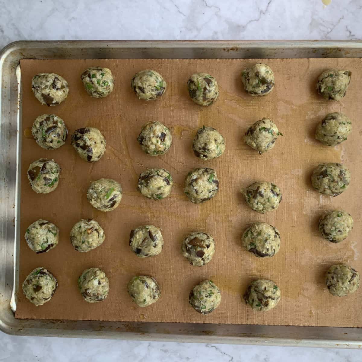 Forming eggplant balls.