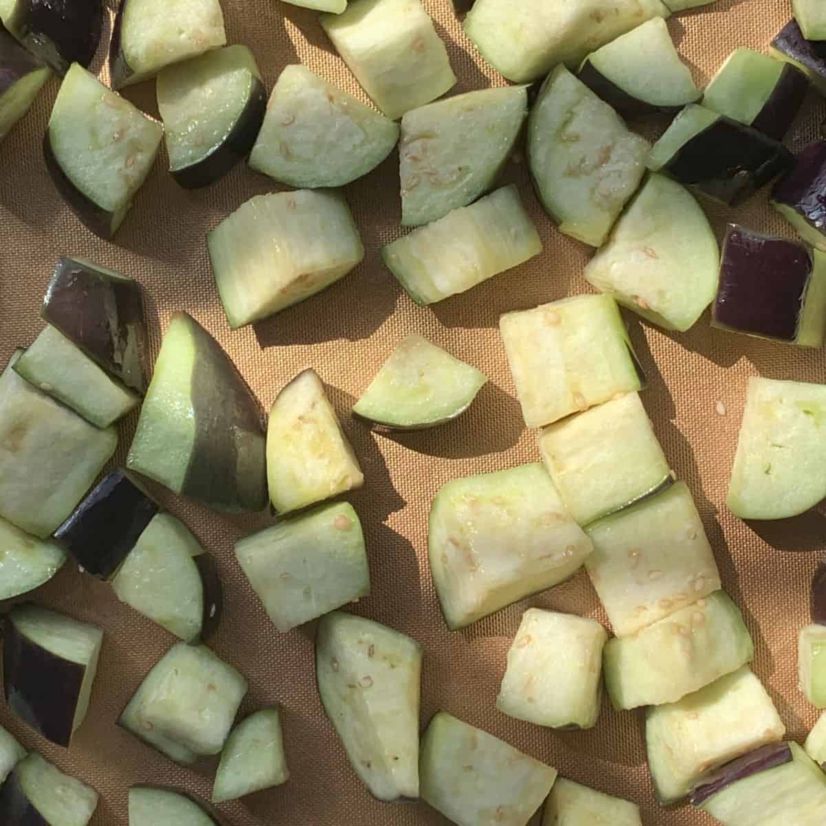 Cubbed eggplant on a baking sheet.