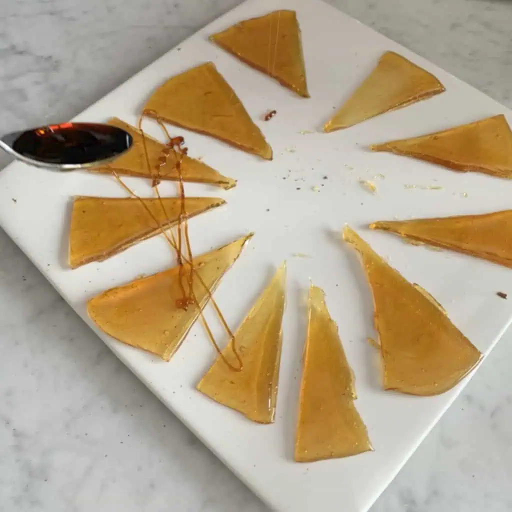 Drizzling caramel on a caramel candy wedges.