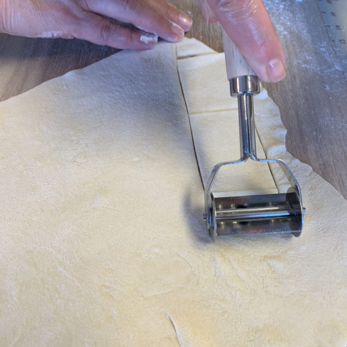 Cutting the dough with the ravioli cutter.
