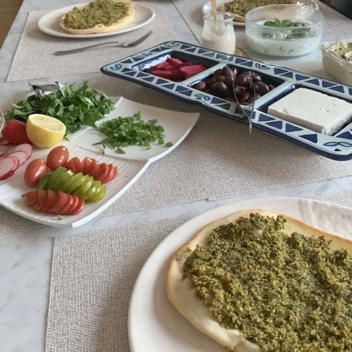 Falafel pizza with different condiments.