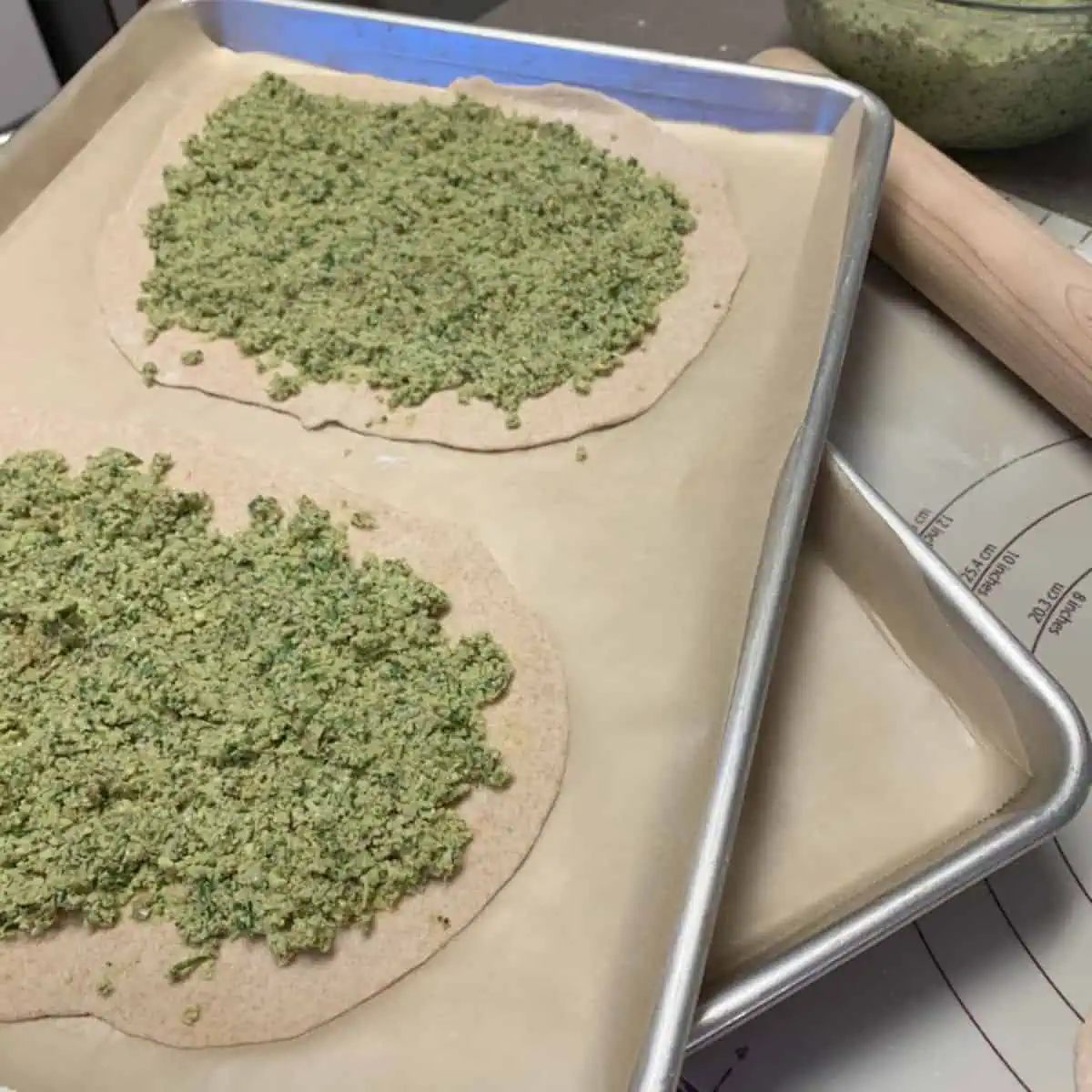 Falafel pizzas on a tray.