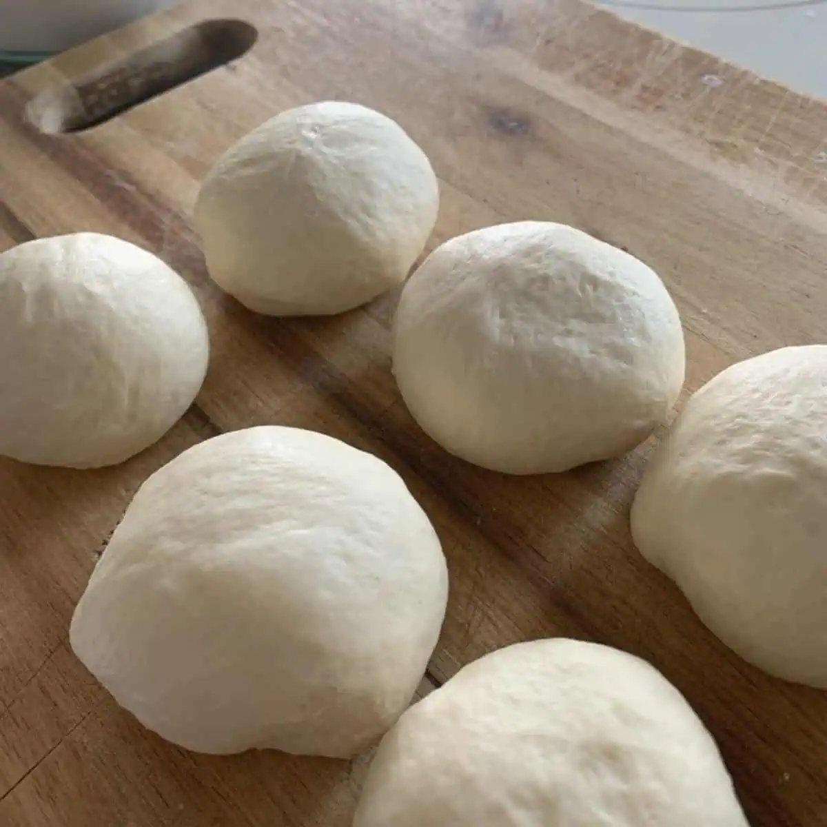 The dough balls on a wooden board