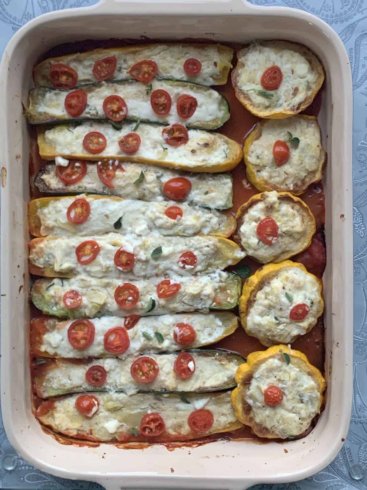 Stuffed pattypan and zucchini in a baking dish.
