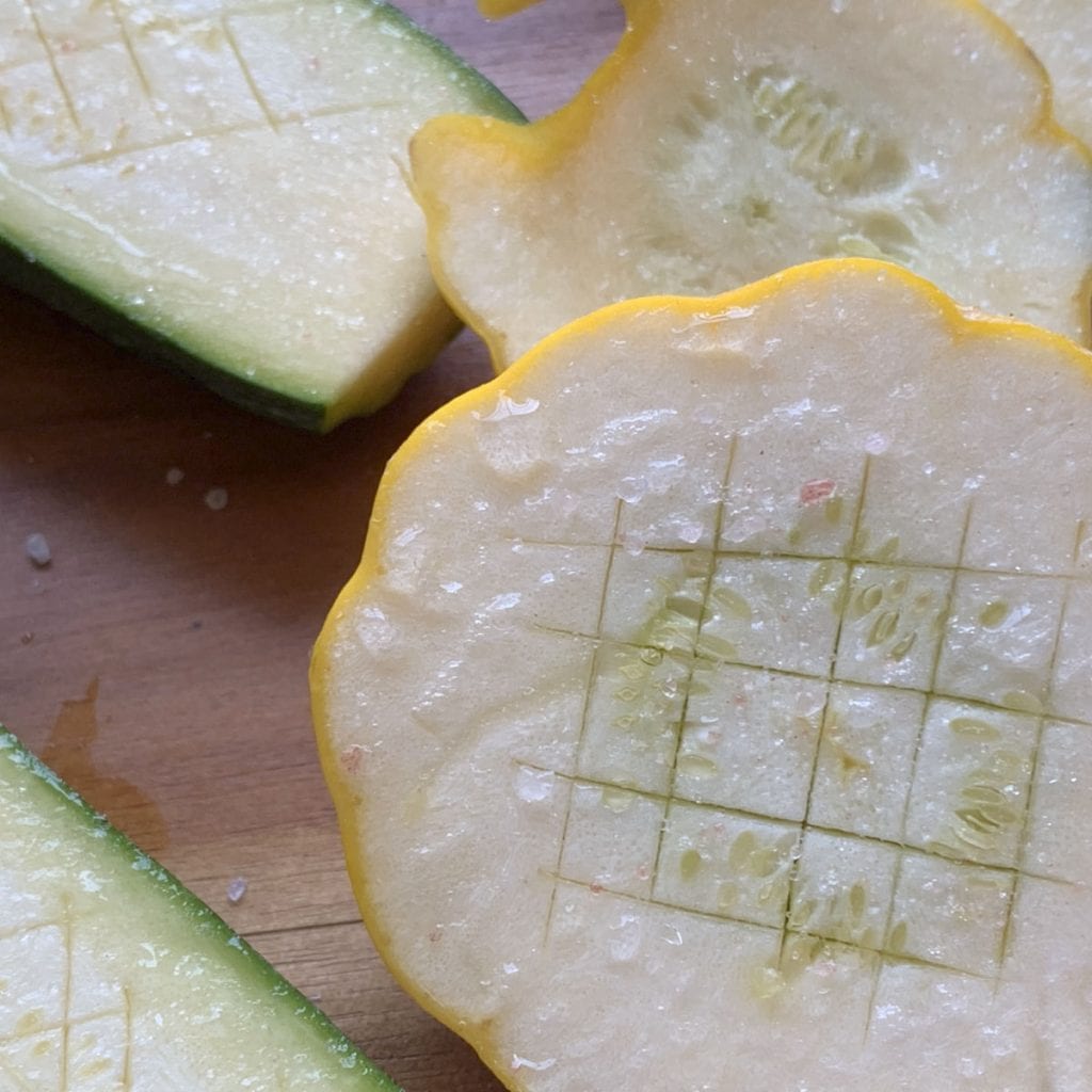 Pattypan zucchini cut in half.