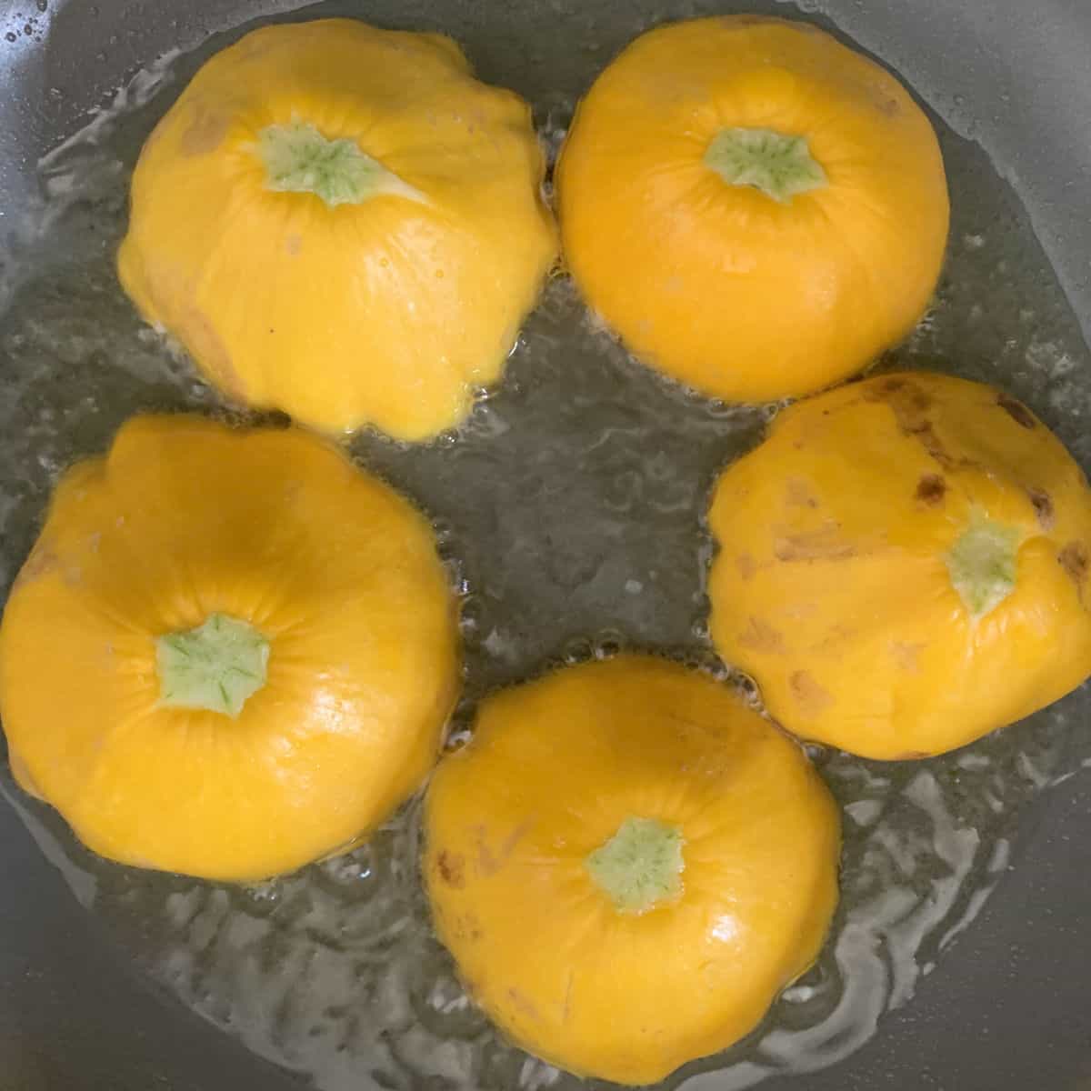 Frying pattypan zucchini.