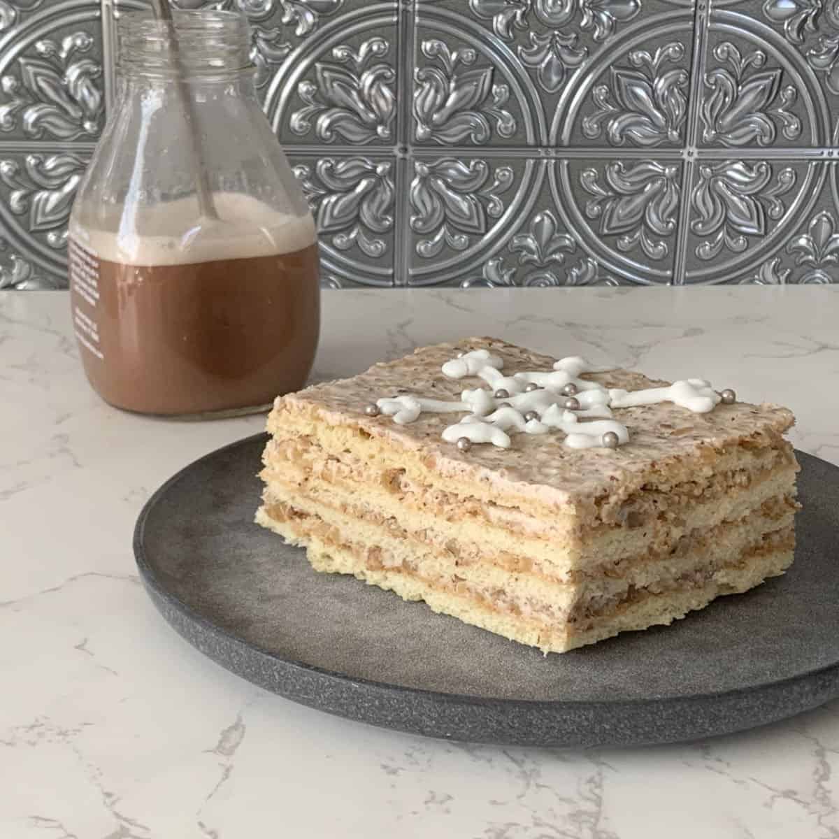 Slice of cake with chocolate milk in the background.