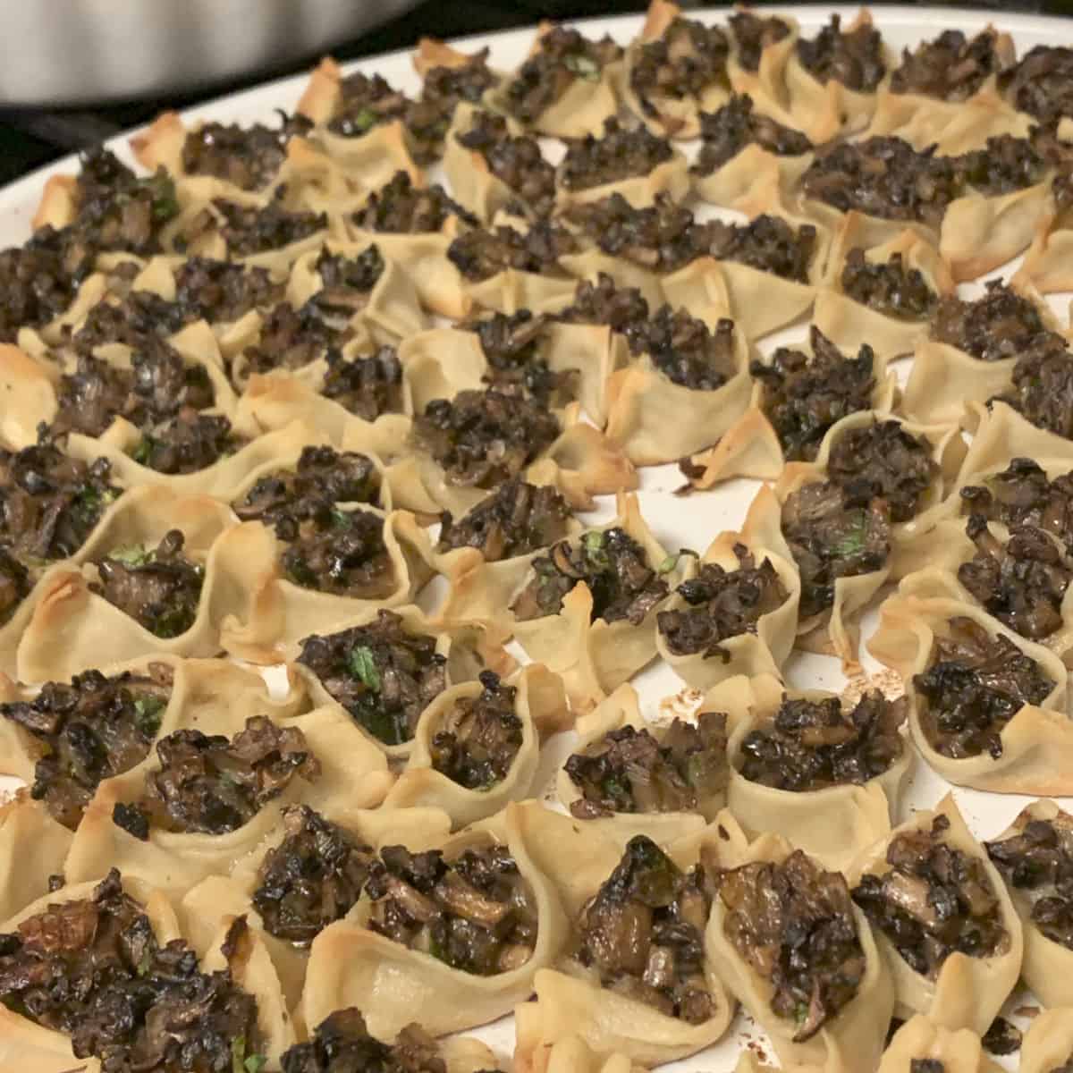 Baked mushroom manti on a tray.