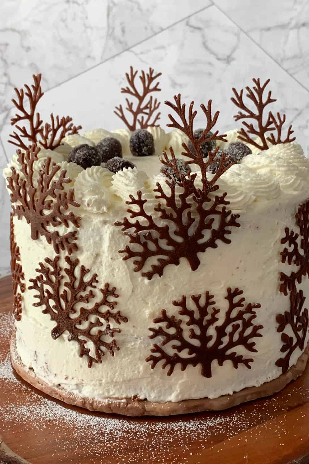 Black forest cake decorated with cherries and tuile cookies.