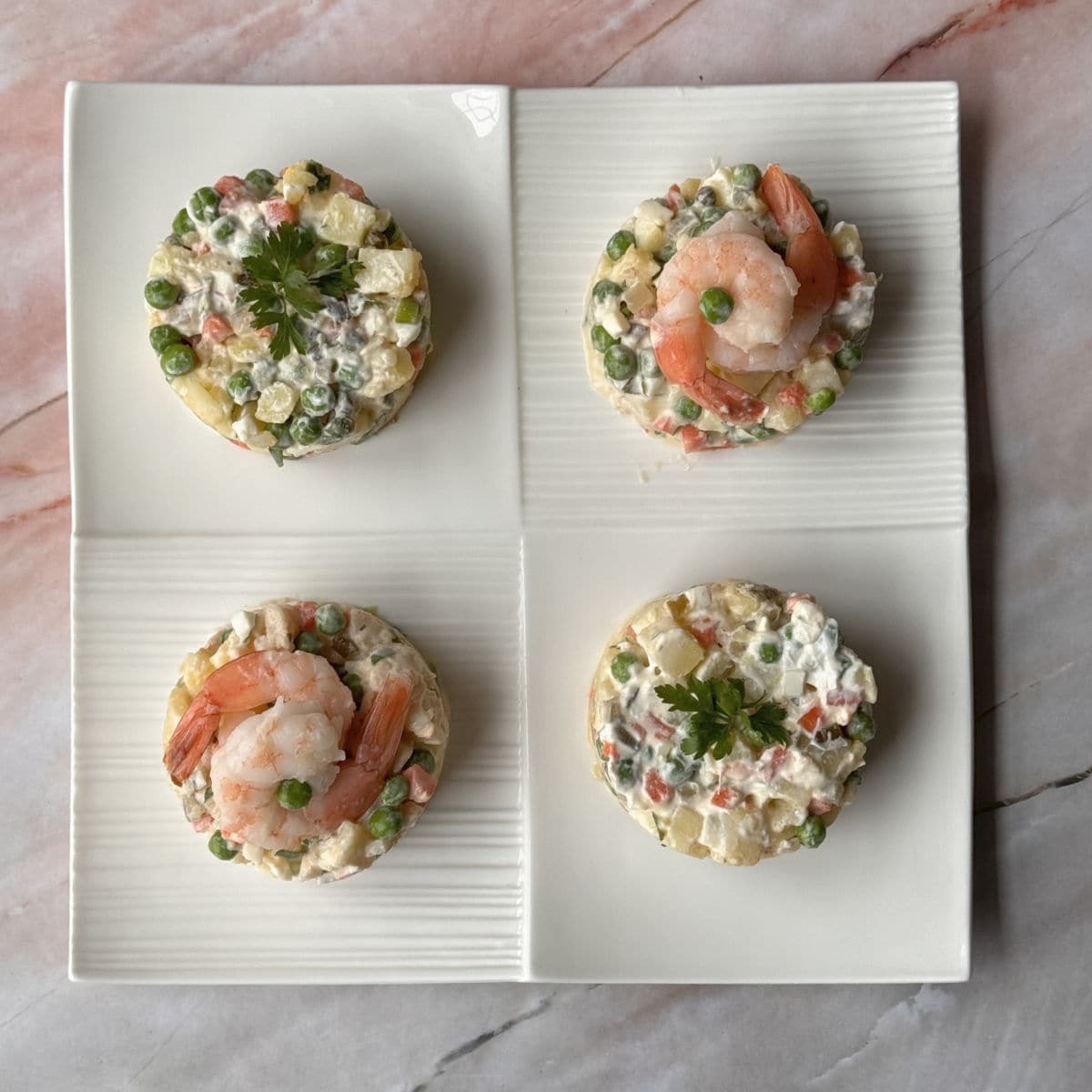 Olivier salad individual portions on a plate.