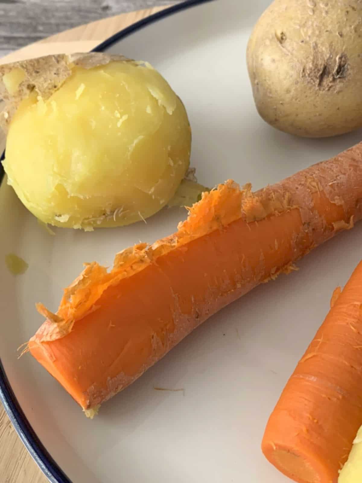 Boiling and peeling potatoes and carrots.