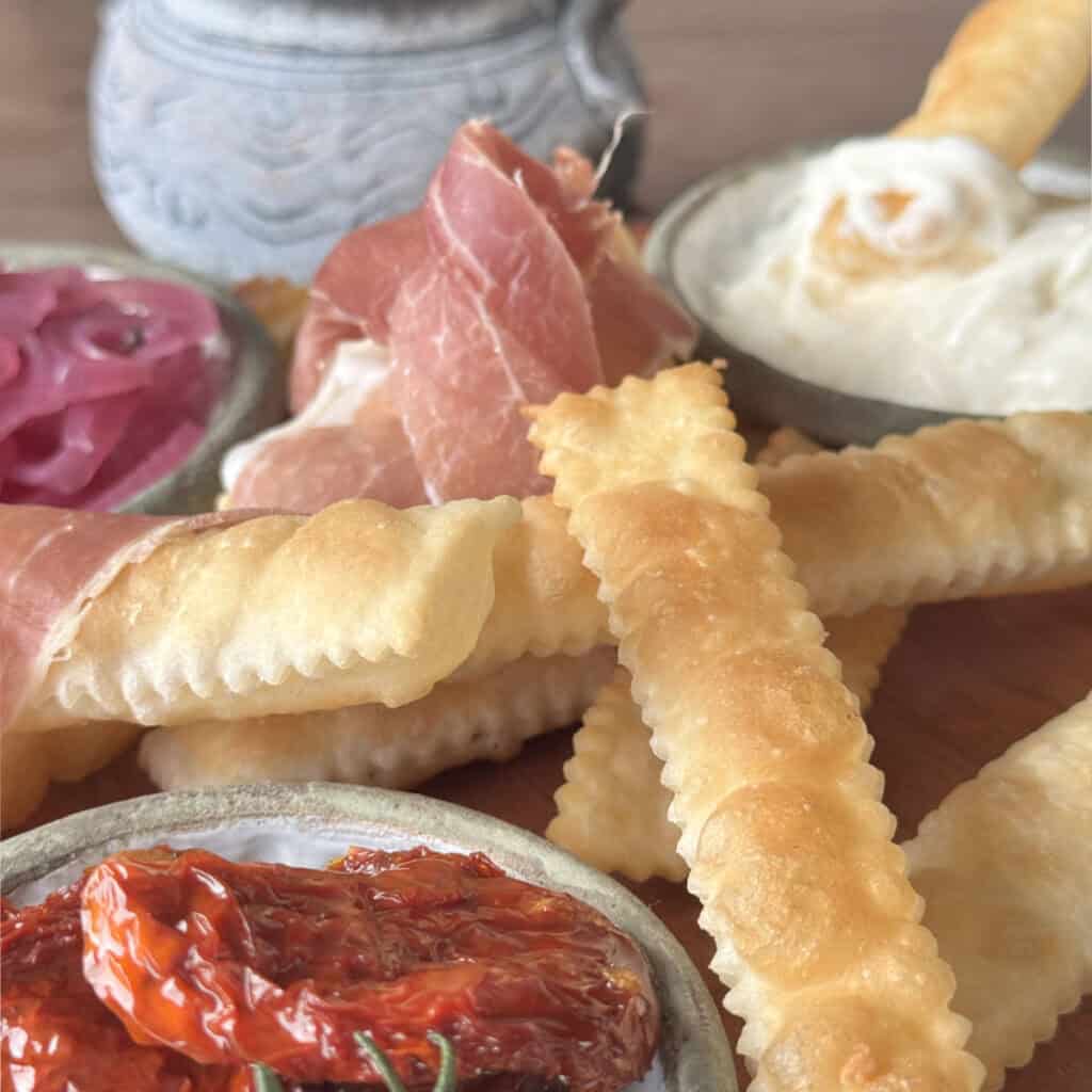 Gnocco Fritto puffy crackers with sundried tomatoes and cheese.