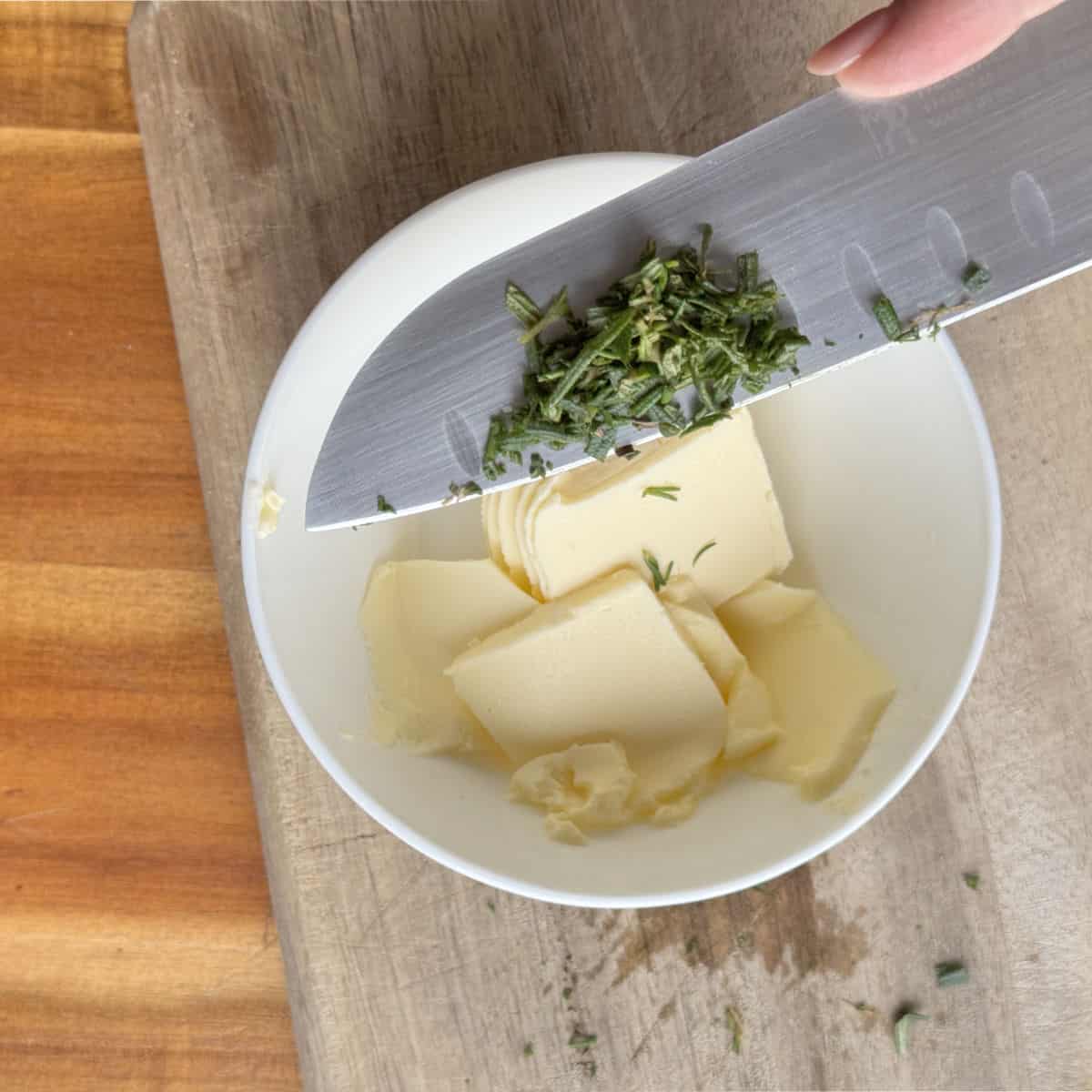 Combining butter and rosemary.