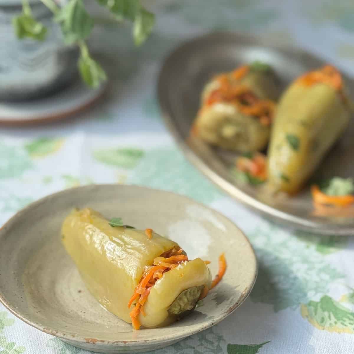 A detailed shot highlighting the stuffed peppers with a little bit of carrots peeking through.