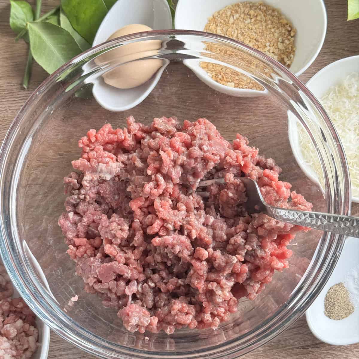 Mixing ground pork and beef.